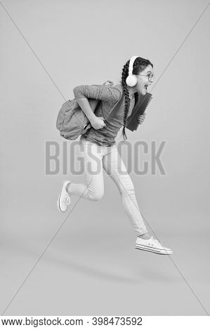 Chase Your Dream. Energetic Kid Hurry To School. Happy Child In Energetic Jump Yellow Background. En