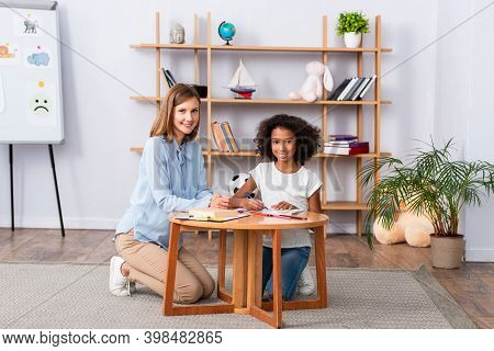 African American Girl With Psychologist On Blurred Background
