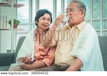 Retired Asian Couple Is Taking Care Of Each Other By Reminding Them To Take Medicine In Cold Winter