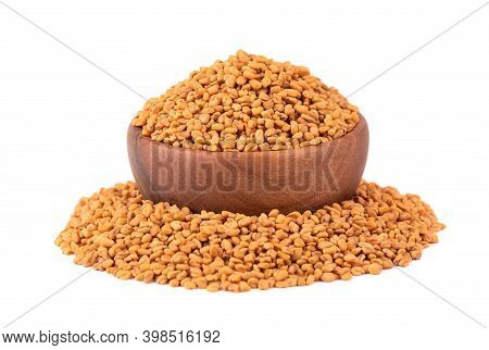 Fenugreek Seeds In Wooden Bowl, Isolated On White Background. Shambala, Helba Seeds.