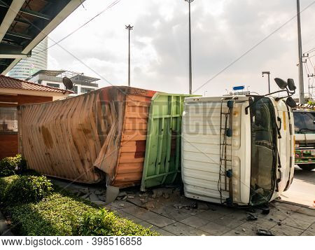 A Truck Carrying A Container Overturned On A Road Under A Bridge Over An Intersection. No Focus, Spe