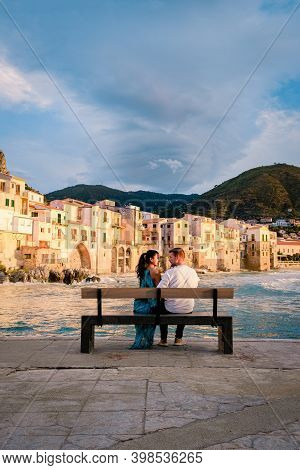 Couple On Vacation Sicily Visiting The Old Town Of Cefalu, Sunset At The Beach Of Cefalu Sicily, Old