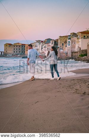 Couple On Vacation Sicily Visiting The Old Town Of Cefalu, Sunset At The Beach Of Cefalu Sicily, Old