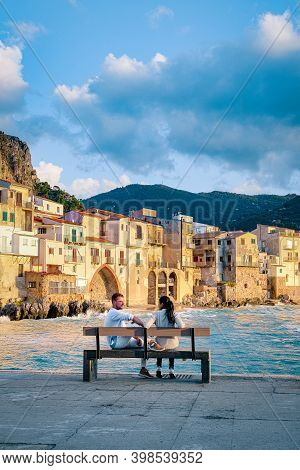 Couple On Vacation Sicily Visiting The Old Town Of Cefalu, Sunset At The Beach Of Cefalu Sicily, Old