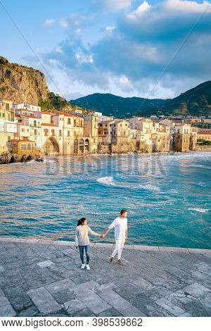 Couple On Vacation Sicily Visiting The Old Town Of Cefalu, Sunset At The Beach Of Cefalu Sicily, Old