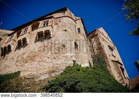 Gothic Imposing Historic Castle Pernstejn At Sunny Summer Day, Stronghold On Rock Above Village Of N