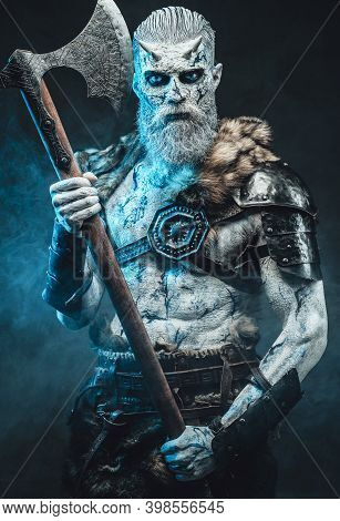 Bringer Of The Death King With Pale Skin Holding Two Handed Axe And Looking Down In Dark Smokey Back