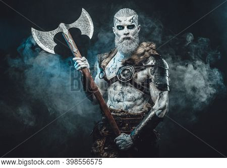 Bringer Of The Death King With Pale Skin Holding Two Handed Axe And Looking Down In Dark Smokey Back
