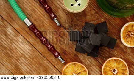 Coals For Hookah On Wooden Background With Dry Oranges And Bowl. Place For Text