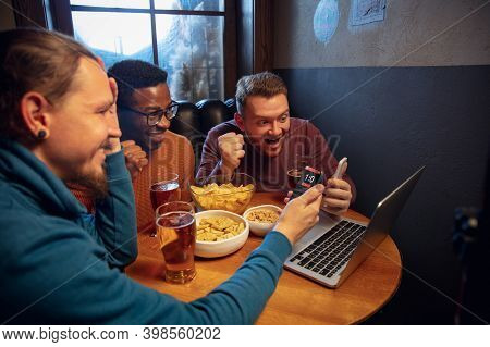 Support. Excited Fans In Bar With Beer And Mobile App For Betting, Score On Their Devices. Screen Wi