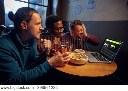 Loose. Excited Fans In Bar With Beer And Mobile App For Betting, Score On Their Devices. Screen With
