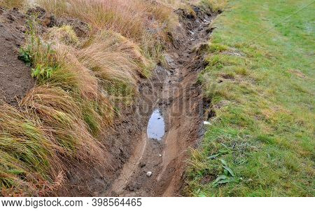 Clayey Soil Into Which Farmers Dig Drainage Ditches So That Their Meadows Are Not Wet For Use On Hay