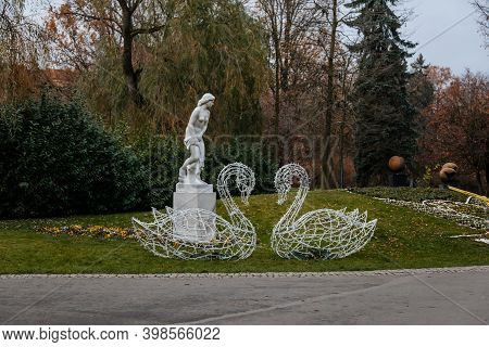 Kolonada Street Decorated By Beautiful Park On One Side, Statue Of A Woman With A Bath Towel, Park I