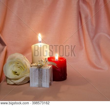 Congratulations On The Holiday. Postcard With Candles And A Rose On A Pink And White Background