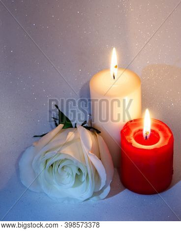Congratulations On The Holiday. Postcard With Candles And A Rose On A Pink And White Background
