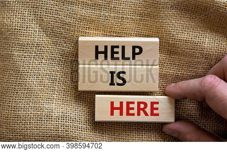 Help Is Here Symbol. Wooden Blocks With Words 'help Is Here'. Beautiful Canvas Background, Male Hand