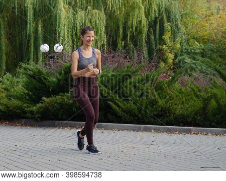 Red-haired Girl Plays Sports On The Playground. Healthy Lifestyle.