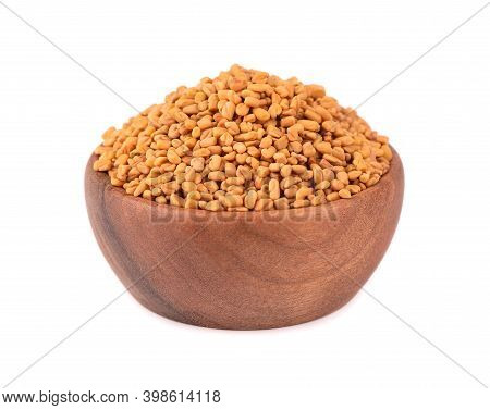 Fenugreek Seeds In Wooden Bowl, Isolated On White Background. Shambala, Helba Seeds.