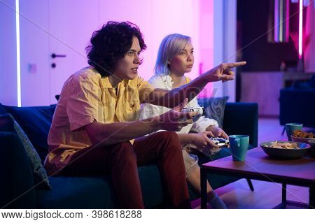 Handsome Young Man Teaching How To Play The Video Games To His Girlfriend, On The Couch, Concept Abo