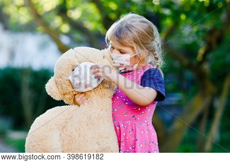 Little Toddler Girl In Medical Mask As Protection Against Pandemic Coronavirus Quarantine Disease. C