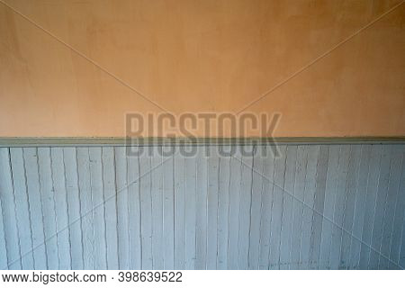 Orange Painted Wall With A Light Blue Painted Chair Rail