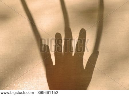 Blurred Shadow Human Arm In Natural Light With Long Lines Shadows, Toned. Help Gesture Or  Request F
