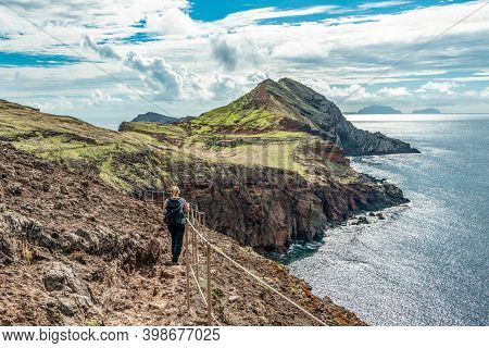 Girl Hiking Rocky Cliffs Clear Near Water Of Atlantic Ocean Bay Ponta De Sao Lourenco, The Island Of