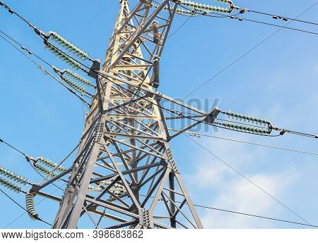 Electric Support, Illuminated By The Bright Sun. Power Transmission Tower Against The Sky. Electric 