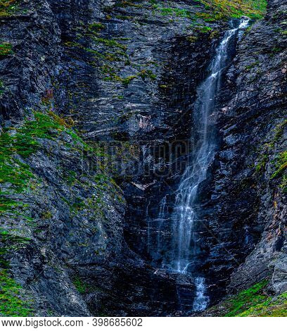 Waterfall Free Falling From A Steep Mountain Slope.