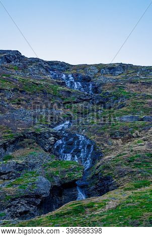 Waterfall Free Falling From A Steep Mountain Slope.