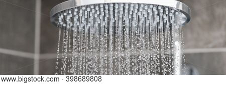 Close-up Of Water Streaming From Rain Shower Head In Bathroom. Sale Of Plumbing Concept.