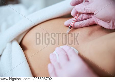 Female Patient Being Injected Into The Decolletage Area