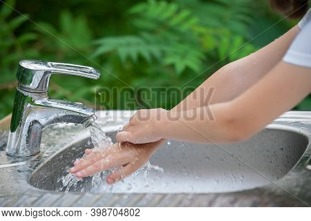 Little Child Washing Hands With Clean Running Water In The Park. Flowing Water From Tap. Metal Washi
