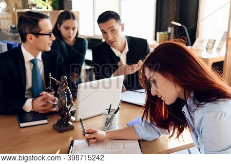 Oppressed Red-haired Woman Signs Document On Deprivation Of Guardianship.