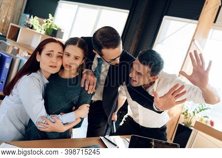 Family Lawyer Is Holding Back Invasive Adult Man Who Is Trying To Hit Restless Wife With Daughter.