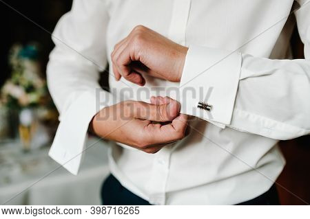 Handsome Man Buttoning Cufflinks On White Shirt. Grooms Elegant Male Gold Cufflink. Wedding Preparat