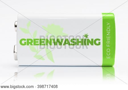 Carrara, Italy - December 9, 2020 - 9 Volt Green And White Battery With The Word Greenwashing Printe
