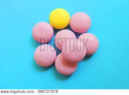 Vitamins Pills Laid Out In The Shape Of An  Abnormal Flower On A Blue Background