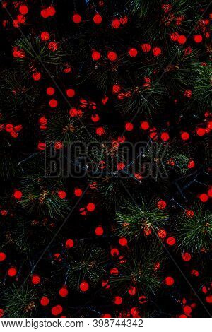 Red Background Abstract Bokeh Christmas. Christmas Twinkled Bright Falling Stars On The Fir Tree. Wi