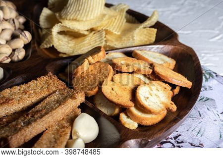 Wooden Bamboo Plate With Beer Snacks Set: Pistachios, Chips, Garlic Cronuts And Fried White Bread
