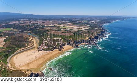 Aerial Panorama Of The Village And Odeceixe Beach, In Summer Overlooking The Algarve. Portugal