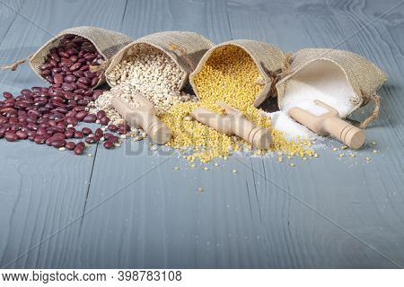 Studio Lighting. Retro Style Wooden Background. There Are Cereals On It. Red Beans, Millet, Pearl Ba