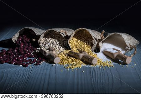 Studio Lighting. Red Paprika Spice On A Wooden Spoon, On A White Background. There Is A Shadow. Clos