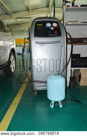 A Gray Station For Refueling Car Air Conditioners With A Freon Cylinder Connected To It Is Located I