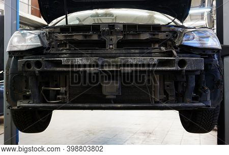 Modern Car In A Car Service On A Lift. Front Bumper Removed From Vehicle. Body Repair.