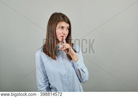 Index Finger On Lips, Silence Gesture, Shhh Quiet, Asks For Voicelessness Forefinger At The Mouth. Y