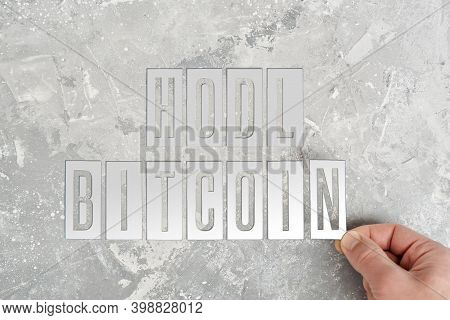 Man Folds The Inscription Hodl Bitcoin From Metal Plates