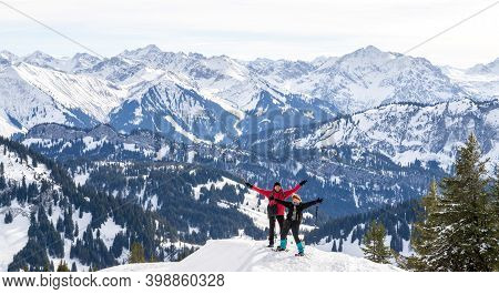 Senior Couple Is Snowshoe Hiking In Alpine Snow Winter Mountains Panorama. Happy Successful People W
