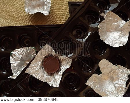 Individual Silver Wrapped Chocolates With Different Fillings In A Box. High Quality Photo