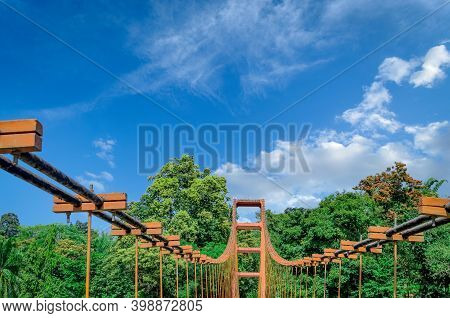 Top Of An Old, Rusty Hanging Bridge In Ezhattumugham, Athirappilly, Kerala, India, With A Clear Blue
